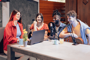 A group of students sat together recording a podcast