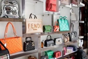 Counterfeit fakes of bags of famous world brands of fashion accessories for sale at market - Gucci, Yves Saint Laurent, Chanel and others